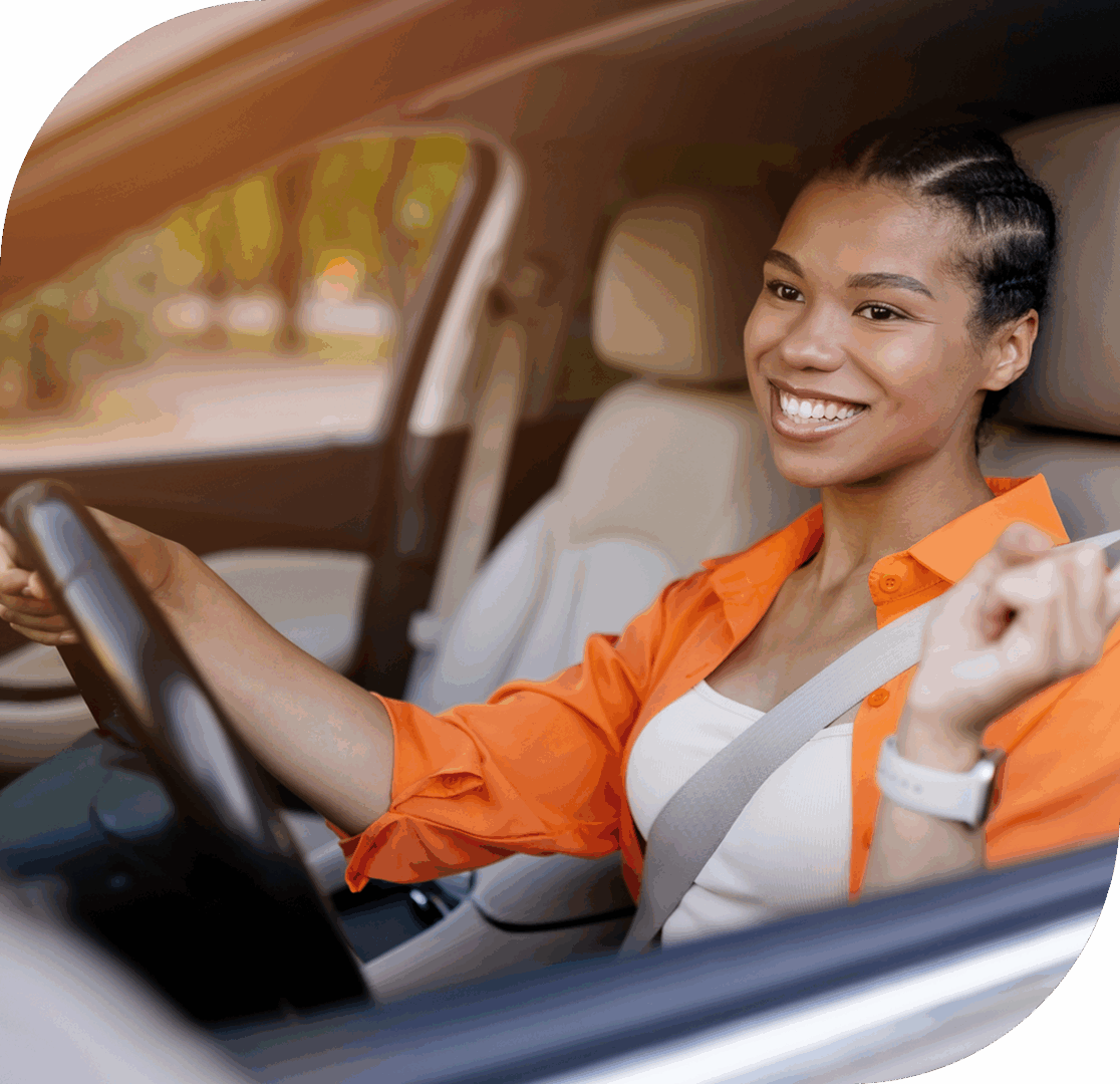 Smiling woman driving a car confidently.