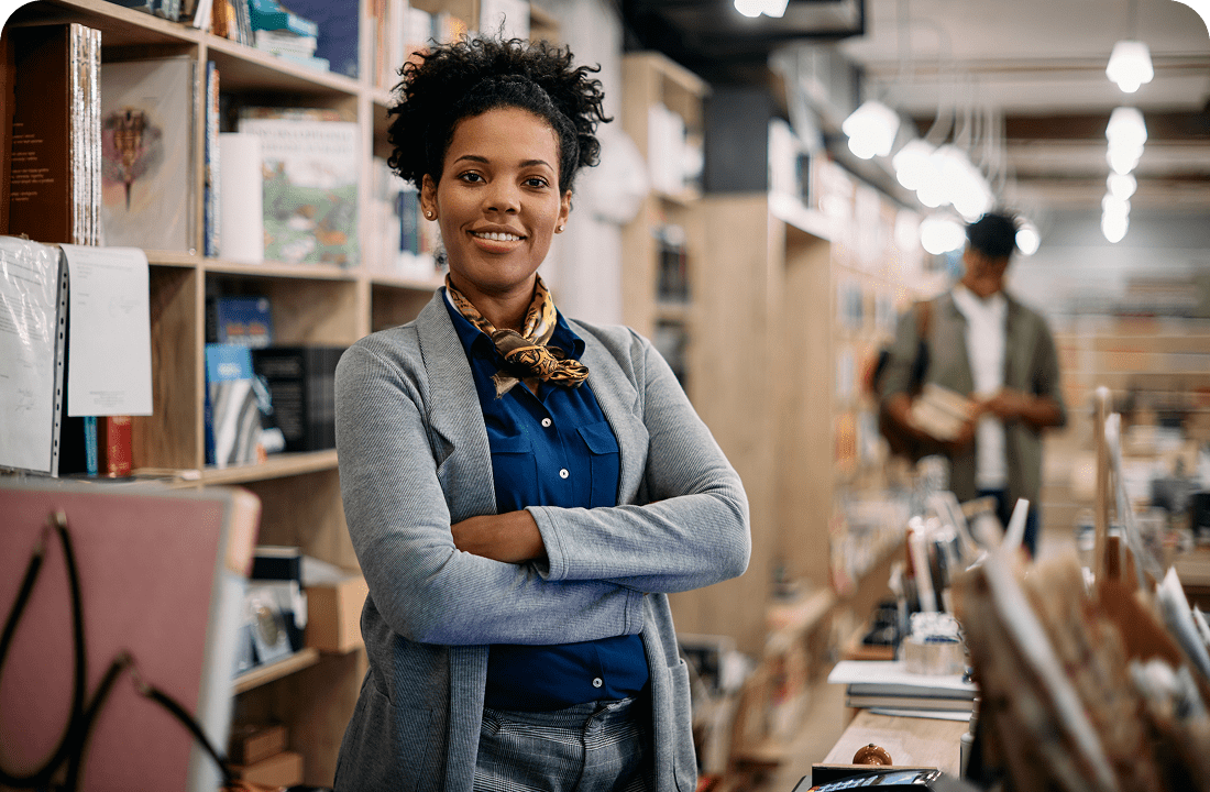 Woman standing confidently in a bookstore.