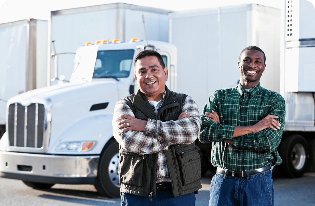 Two men smiling in front of truck.
